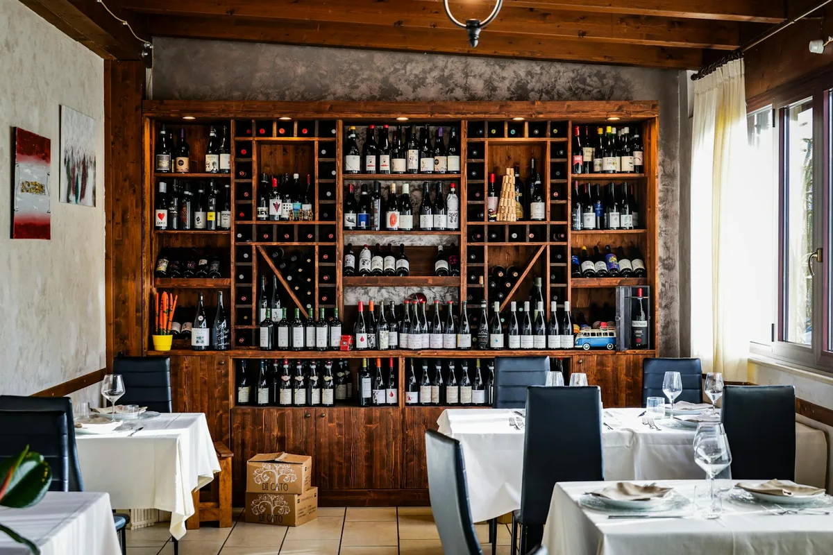 Chic restaurant interior with a comprehensive wine collection on display.